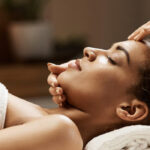 cropped-attractive-african-woman-enjoying-face-massage-in-spa-salon.jpg